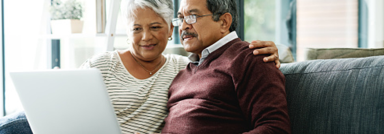 Mature couple looking at laptop computer