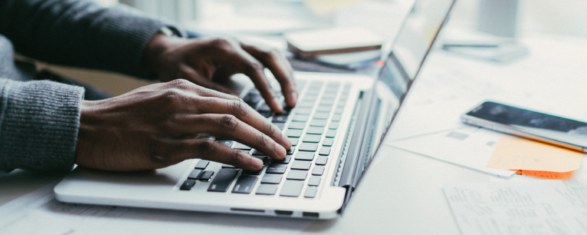 hands typing on computer